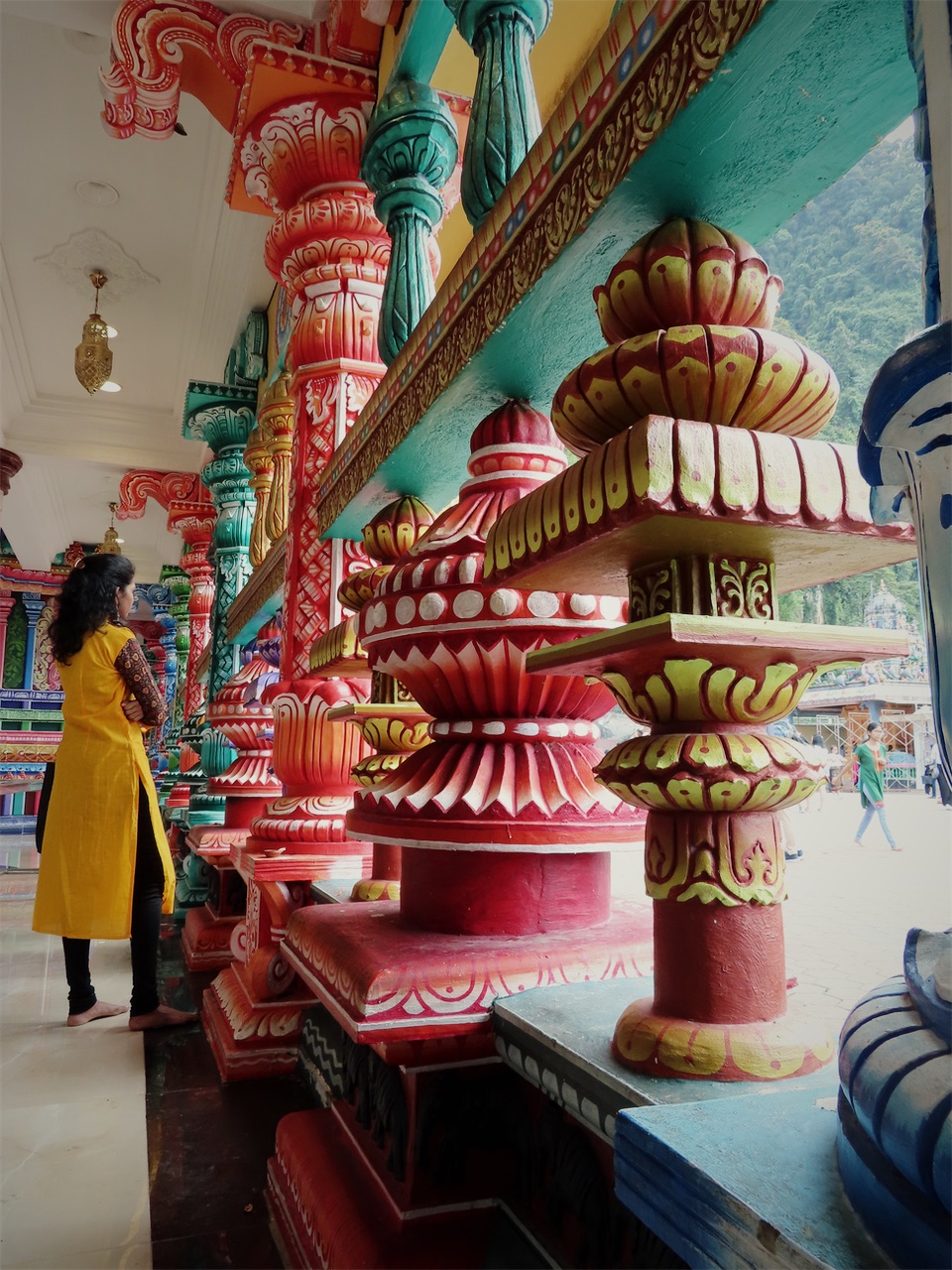 Brightly painted temple columns in red, green and gold