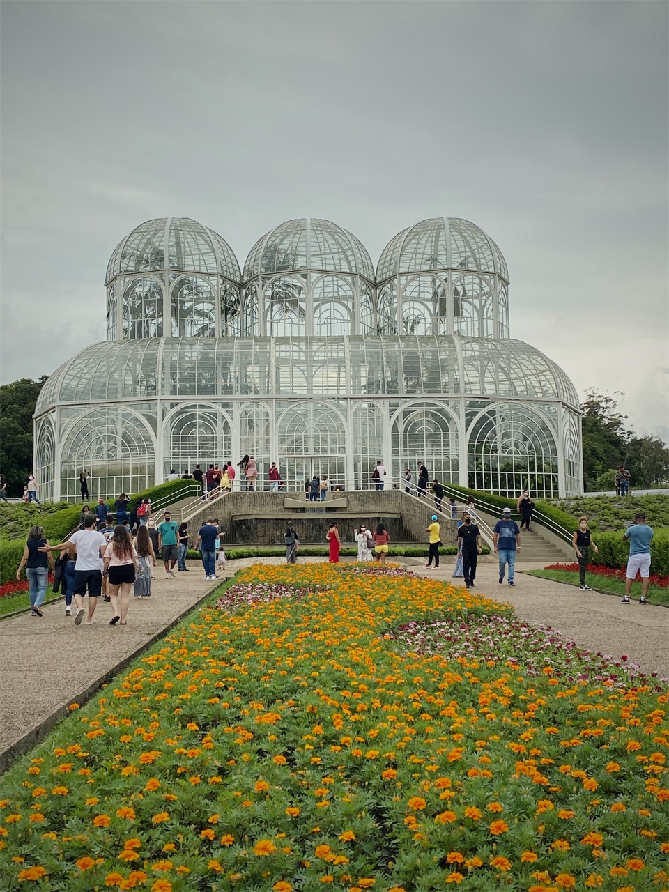 The glass greenhouse of the Botanical Garden with flower beds in front